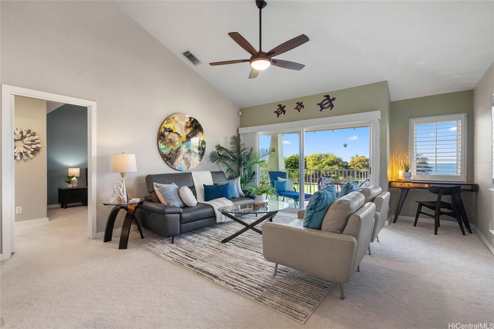 92-1001 Aliinui Drive, Unit 25C Kapolei, HI 96707 - Photo 21 of 25 a living room with furniture and a large window