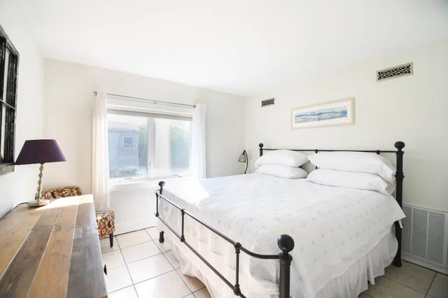 a bedroom with a bed and a lamp