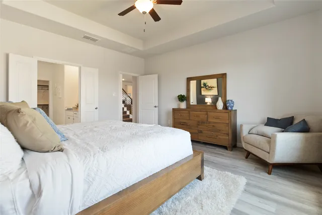 a spacious bedroom with a bed and a couch