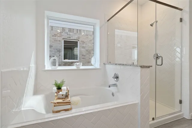 a en suite bathroom with a double vanity sink and a mirror