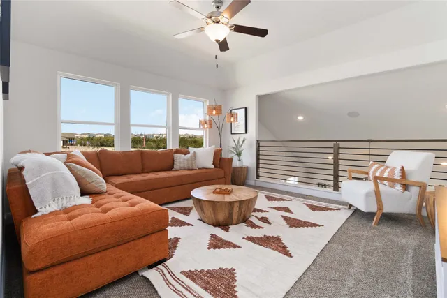 a living room with furniture and a wooden floor