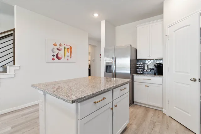 a kitchen with stainless steel appliances granite countertop a refrigerator sink and microwave