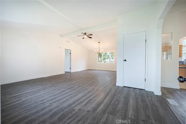 a large kitchen with stainless steel appliances kitchen island granite countertop a sink and a stove