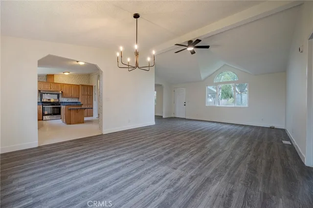 a view of a dry yard with trees