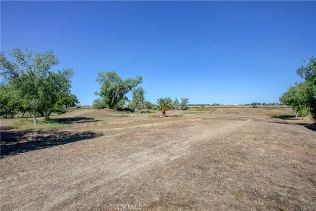 a view of a chair and table on the side of the road