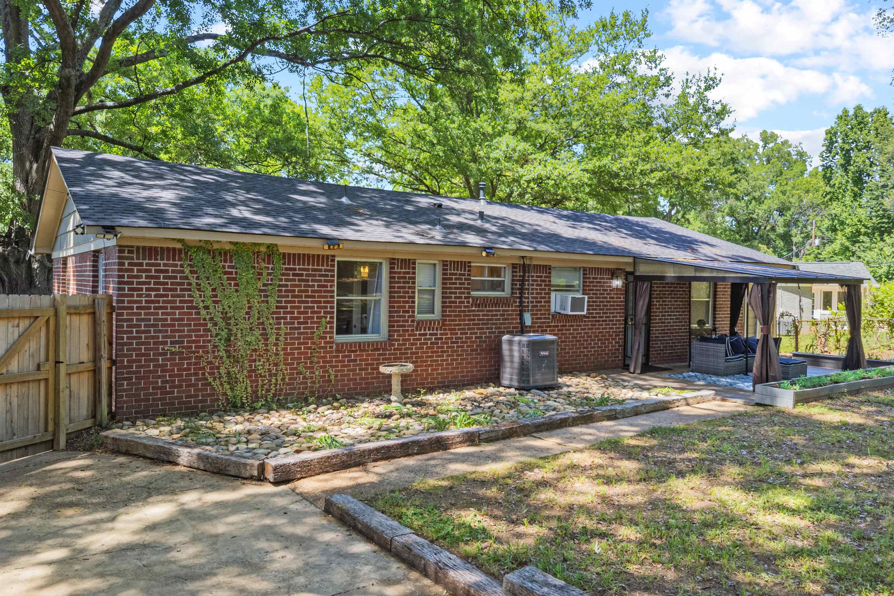 5271 Princeton Road Memphis, TN 38120 - Photo 9 of 30 Brick exterior with a dark shingle roof and a covered patio area