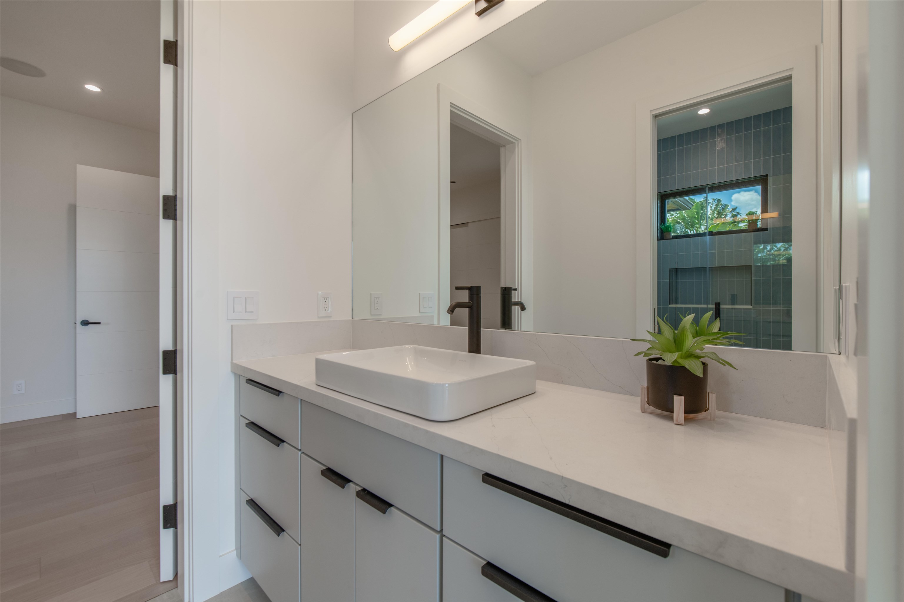 111 Mehana Road, Unit A Haiku, HI 96708 - Photo 34 of 50 a bathroom with a sink double vanity and a mirror
