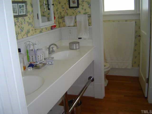 2106 Cowper Drive Raleigh, NC 27608 - Photo 11 of 12 a bathroom with a sink a mirror and shower