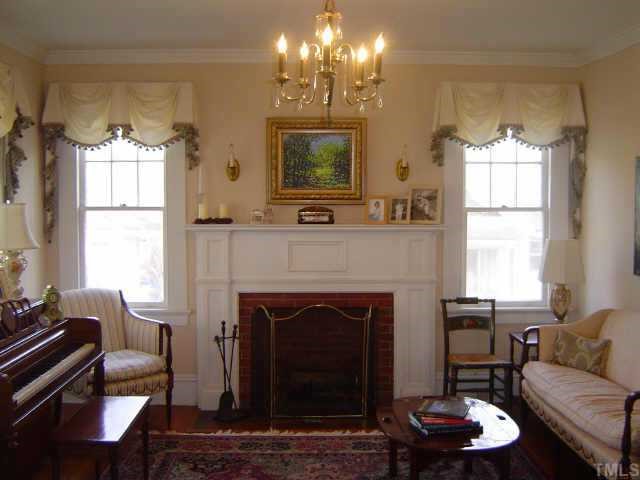2106 Cowper Drive Raleigh, NC 27608 - Photo 6 of 12 a living room with furniture and a fireplace