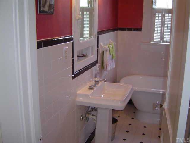 2106 Cowper Drive Raleigh, NC 27608 - Photo 8 of 12 a bathroom with a sink a toilet and shower
