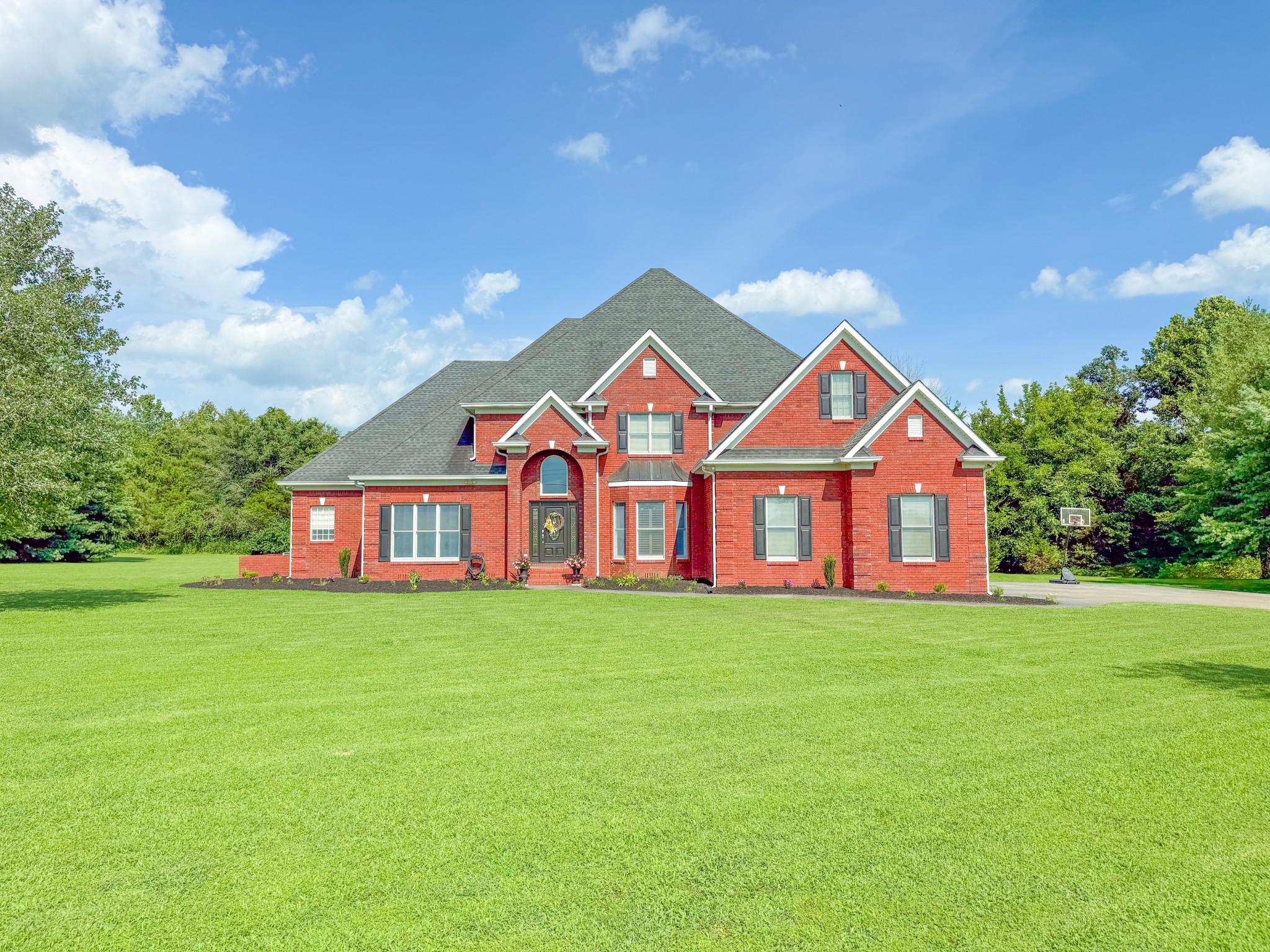 a front view of a house with garden