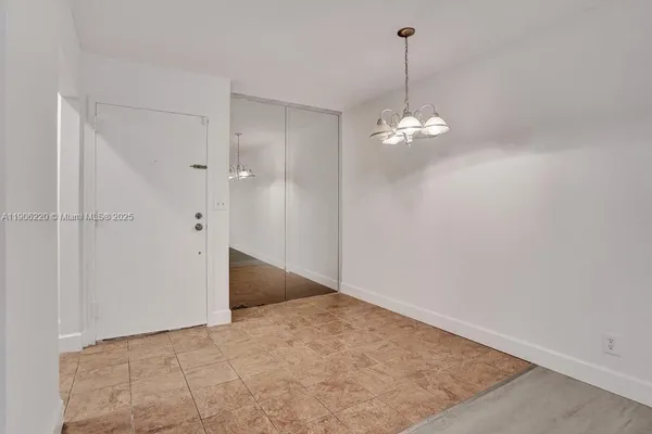 a view of a chandelier in big room and chandelier fan