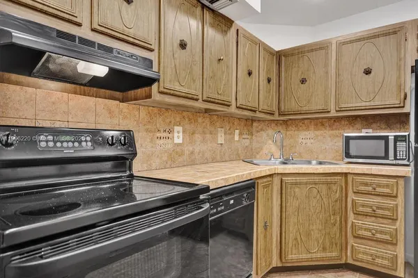 a kitchen with stainless steel appliances granite countertop a sink and cabinets