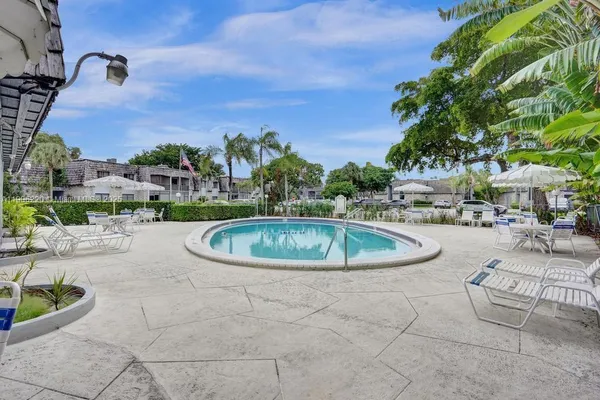 a view of house with a swimming pool and outdoor seating