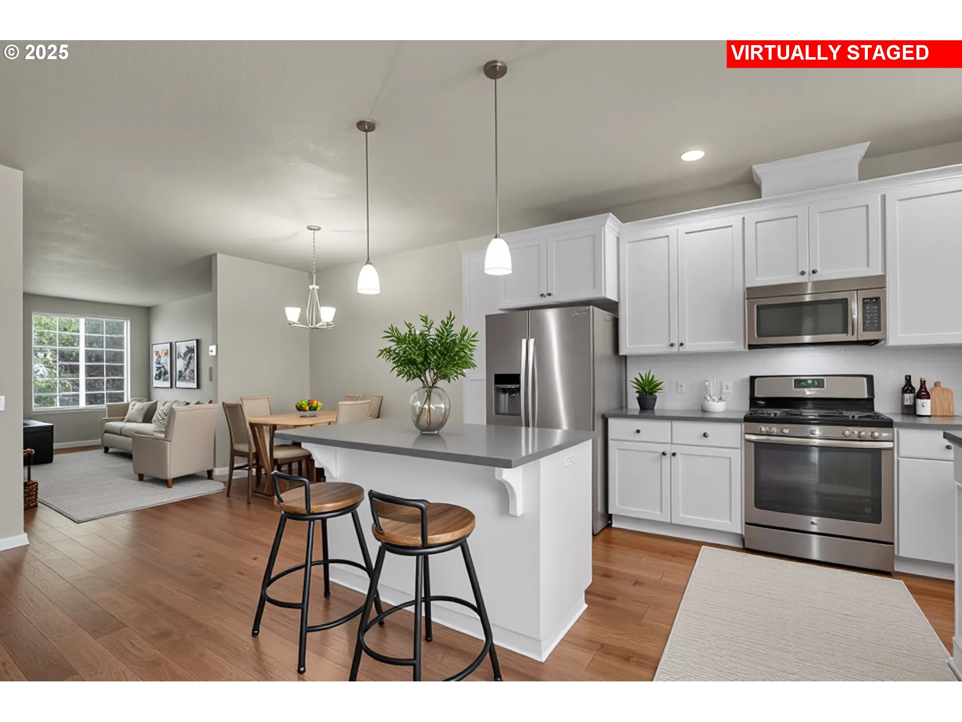 18370 Southwest Anna Mae Lane Beaverton, OR 97003 - Photo 11 of 29 a kitchen with stainless steel appliances kitchen island granite countertop a refrigerator a stove a sink a dining table and chairs with wooden floor