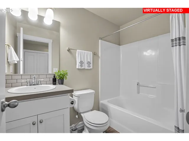 a bathroom with a sink toilet vanity and shower