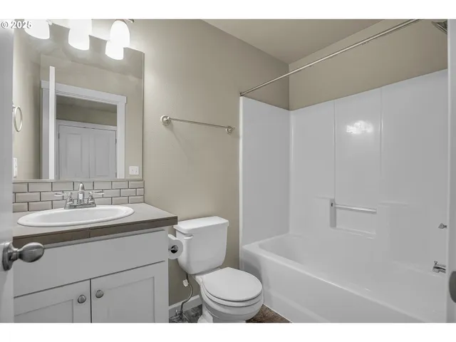 a bathroom with a sink toilet vanity and shower