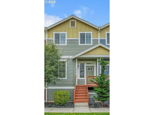 a view of a house with a yard and potted plants