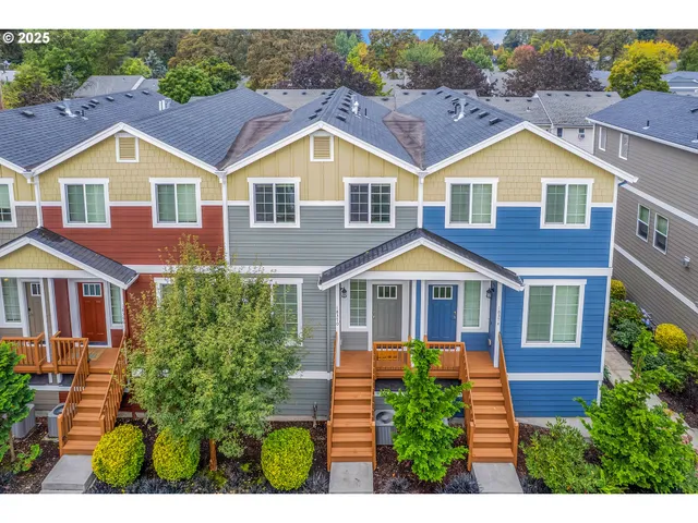 a view of a yard in front of a brick house with a small yard