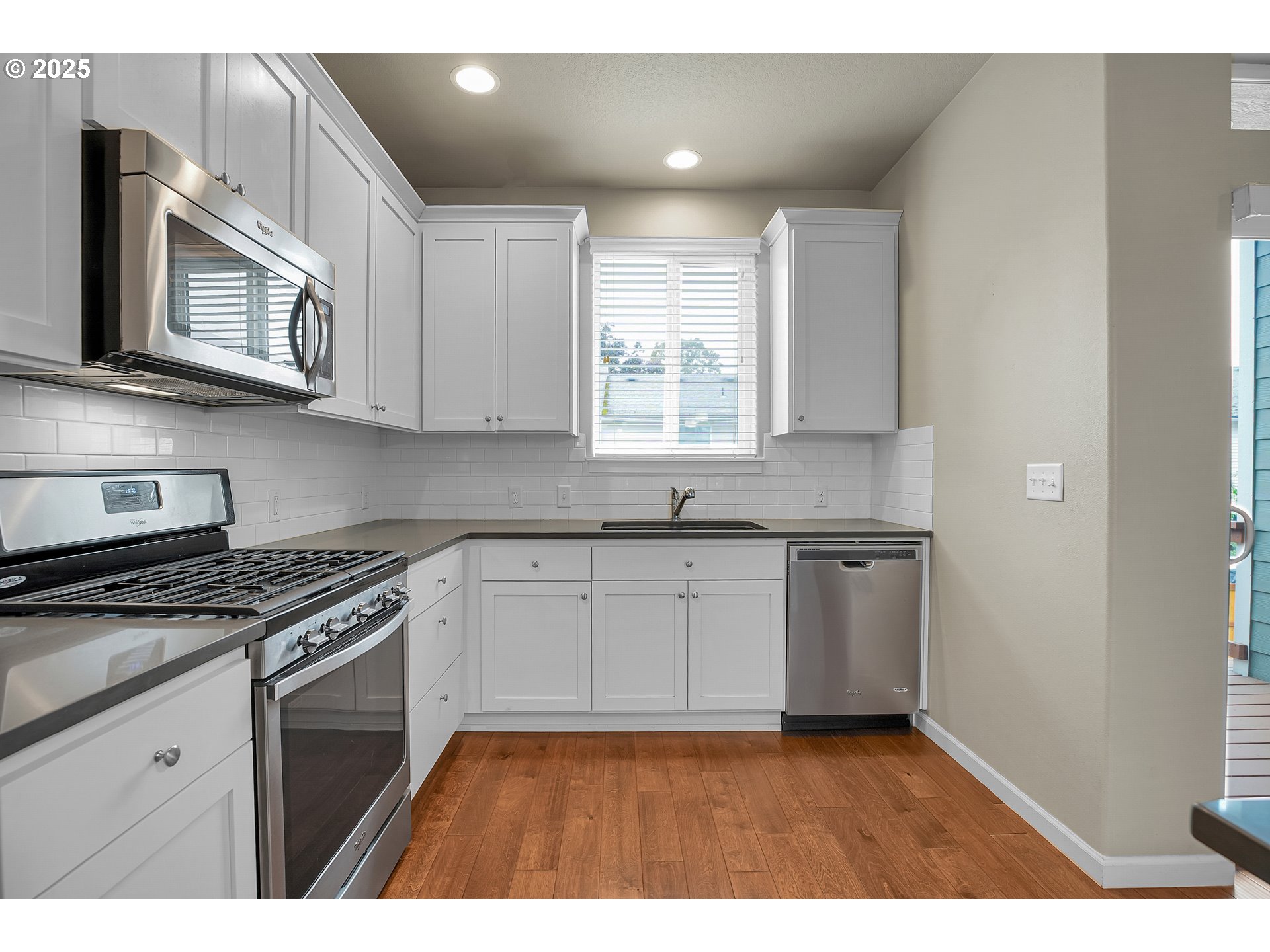 18370 Southwest Anna Mae Lane Beaverton, OR 97003 - Photo 10 of 29 a kitchen with stainless steel appliances granite countertop a sink a stove a microwave and cabinets