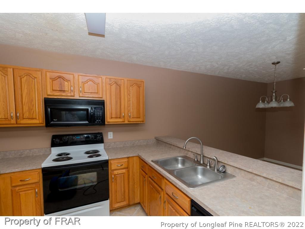 1941-3 Sardonyx Road Fayetteville, NC 28303 - Photo 11 of 27 a kitchen with a sink a stove and microwave