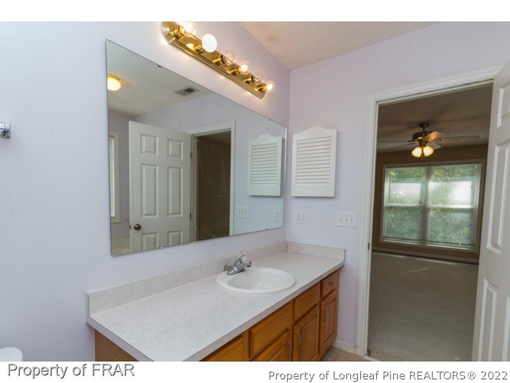 1941-3 Sardonyx Road Fayetteville, NC 28303 - Photo 16 of 27 a bathroom with a sink a vanity and mirror