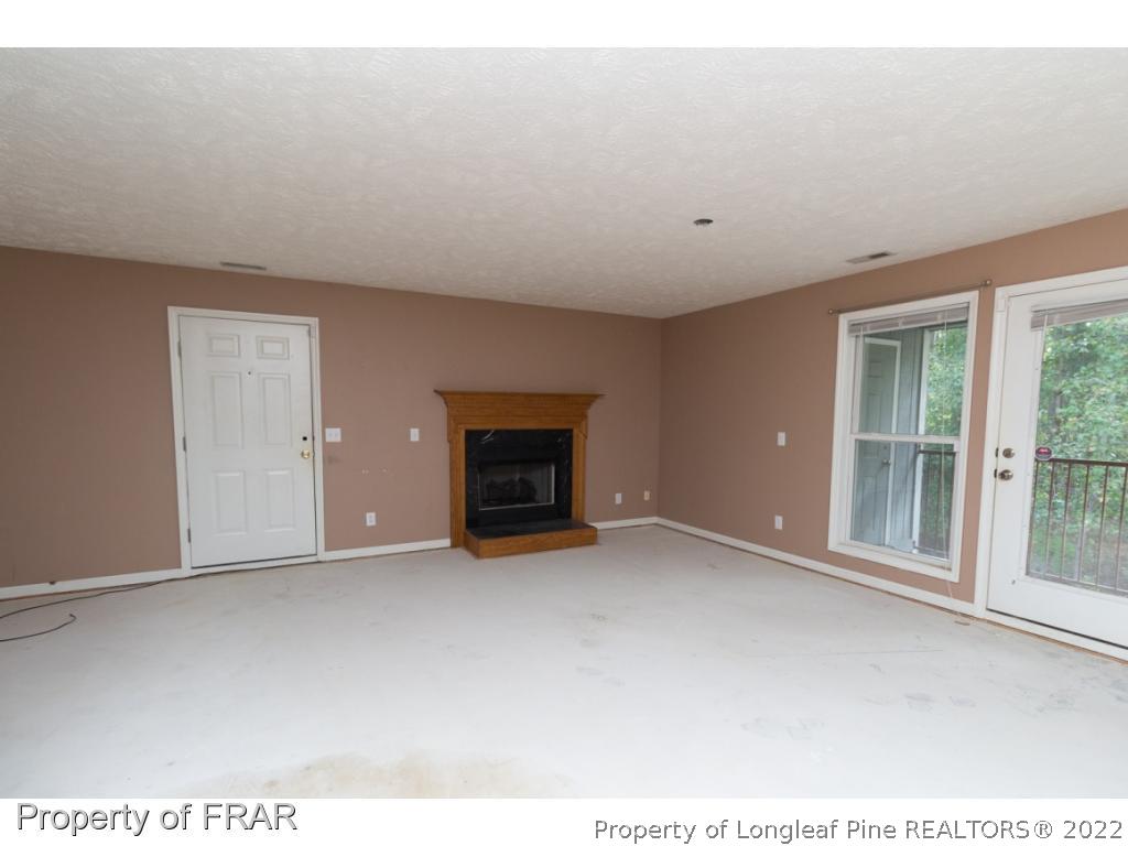 1941-3 Sardonyx Road Fayetteville, NC 28303 - Photo 5 of 27 a view of an empty room with a fireplace