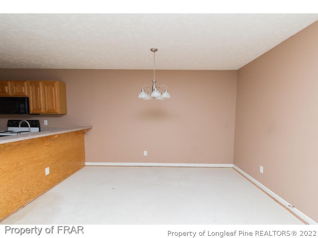 1941-3 Sardonyx Road Fayetteville, NC 28303 - Photo 7 of 27 a view of a kitchen with an empty space and a window