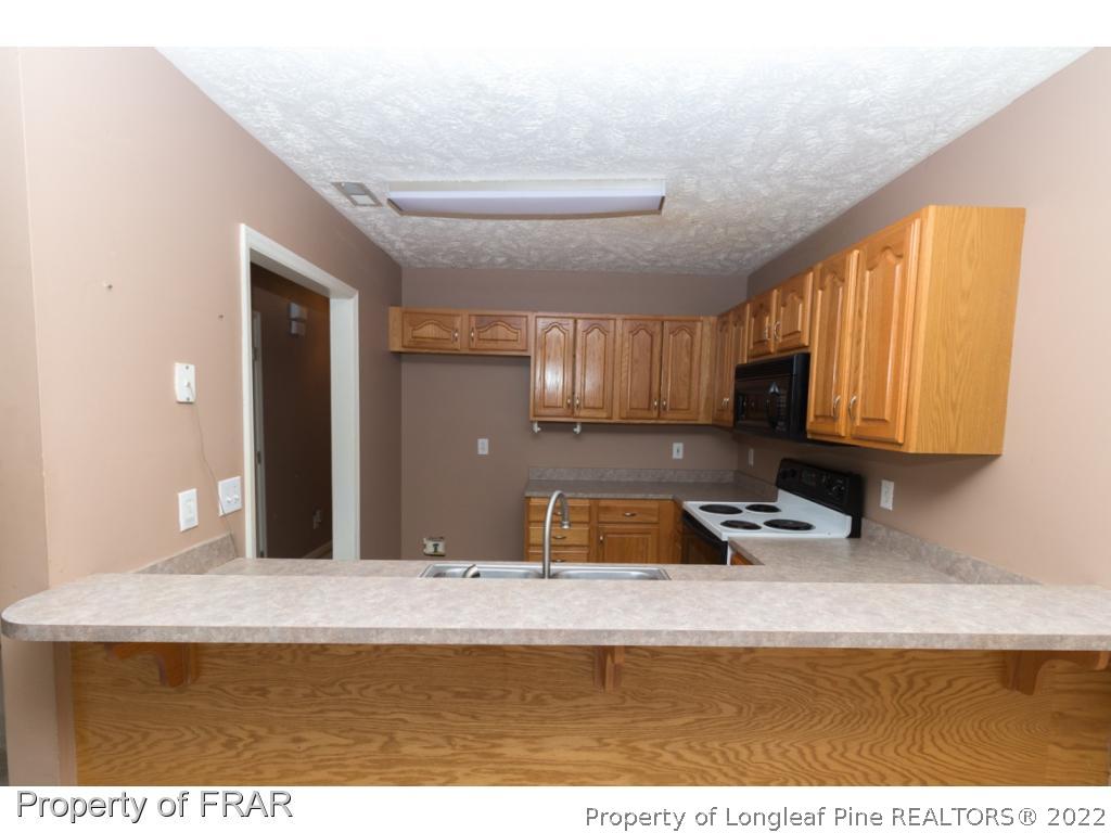 1941-3 Sardonyx Road Fayetteville, NC 28303 - Photo 9 of 27 a kitchen with a sink and a cabinets