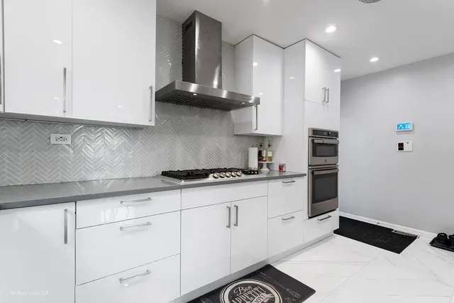 a kitchen with stainless steel appliances granite countertop a sink a stove and a refrigerator