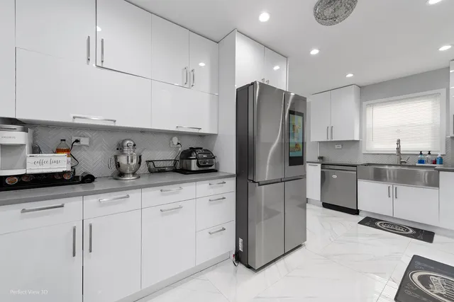 a kitchen with stainless steel appliances granite countertop a refrigerator sink and cabinets