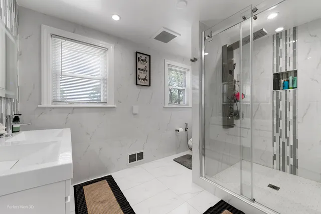 a bathroom with a shower sink and mirror