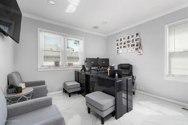 a livingroom with workspace and a couch