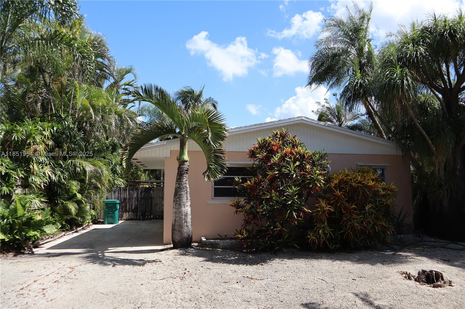 18531 Southwest 268th Street, Unit 18531 Homestead, FL 33031 - Photo 3 of 18 a view of potted plants in front of house