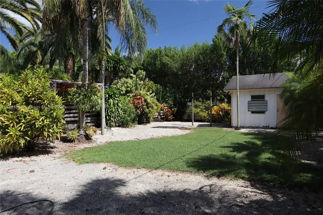 a view of a house with a yard and tree s