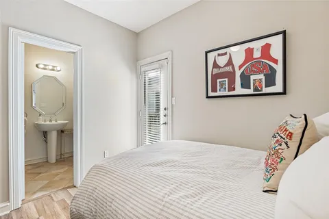 a bedroom with a bed and a painting on the wall