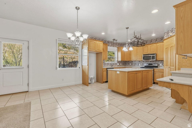 1001 Pine Valley Road Pine Valley, UT 84781 - Photo 15 of 49 Kitchen featuring hanging lights, a center island, light countertops, decorative backsplash, and stainless steel appliances