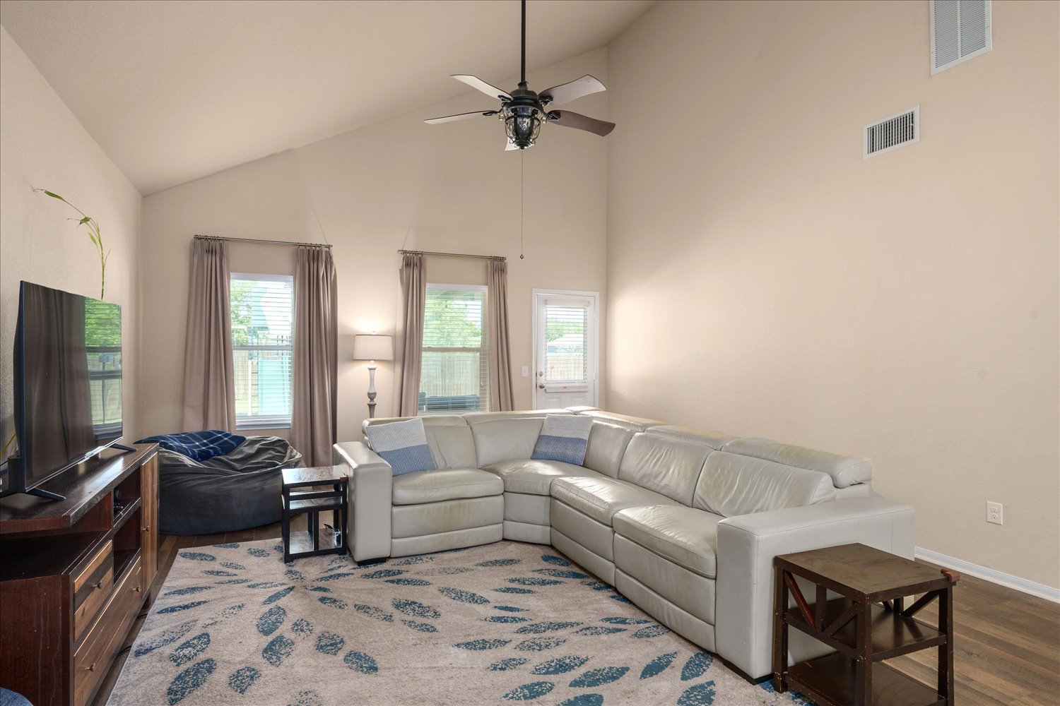717 Kaluga Trail Leander, TX 78641 - Photo 9 of 40 a living room with furniture a ceiling fan and a window