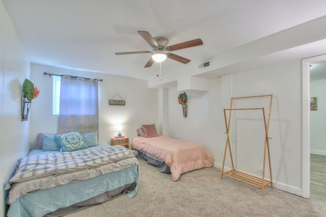 a bedroom with two beds and painting on the wall