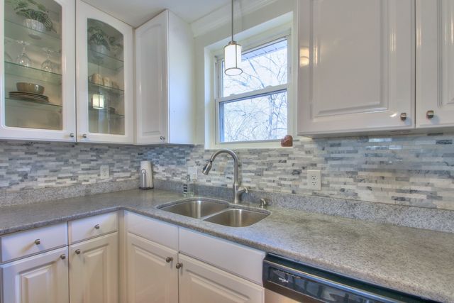 a kitchen with a sink and cabinets
