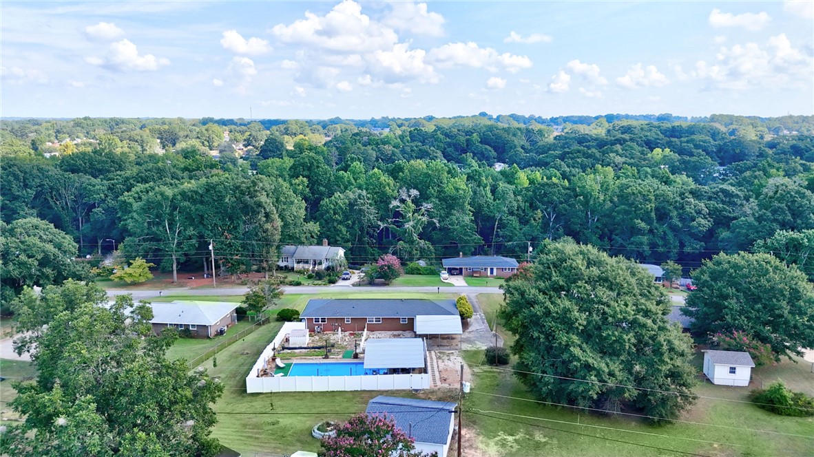 121 Wilson Road Anderson, SC 29625 - Photo 37 of 40 Lush green trees border this quiet neighborhood property with an inviting backyard pool.