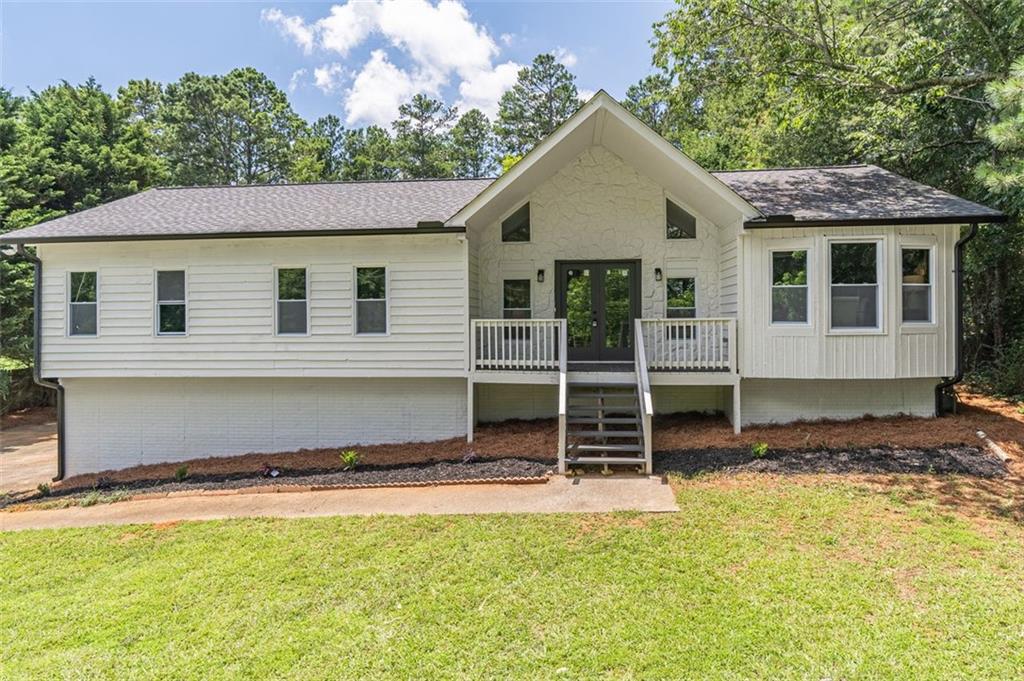 243 Hickory Way Canton, GA 30115 - Photo 1 of 1 a front view of a house with a garden