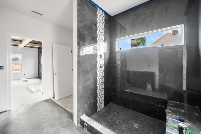 a view of a bathroom with a glass door shower