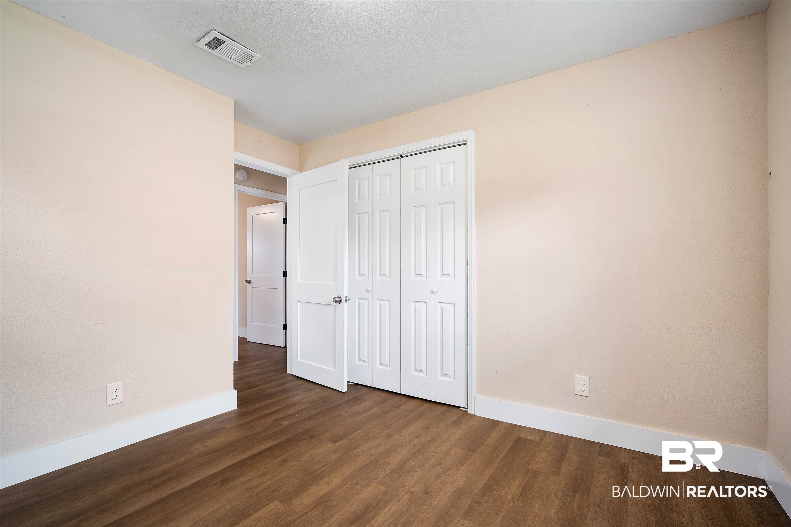 2119 Autrey Avenue Eight Mile, AL 36613 - Photo 15 of 22 Unfurnished bedroom with a closet and dark hardwood / wood-style floors