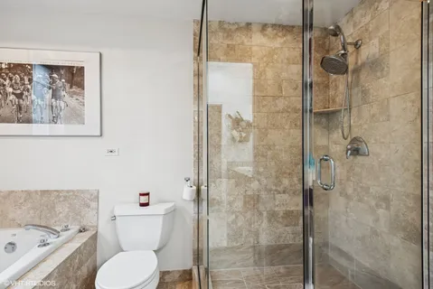 a bathroom with a toilet and a shower
