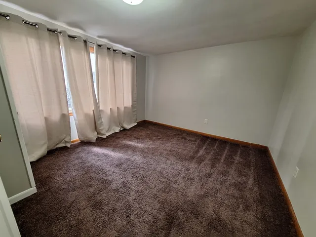 an empty room with closet area