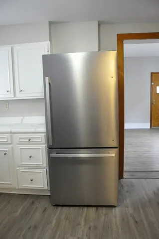 a view of empty room with wooden floor