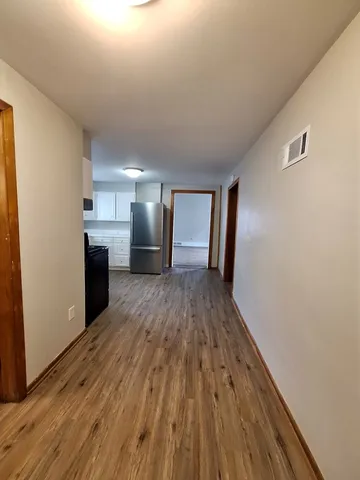 a view of a kitchen from a hallway