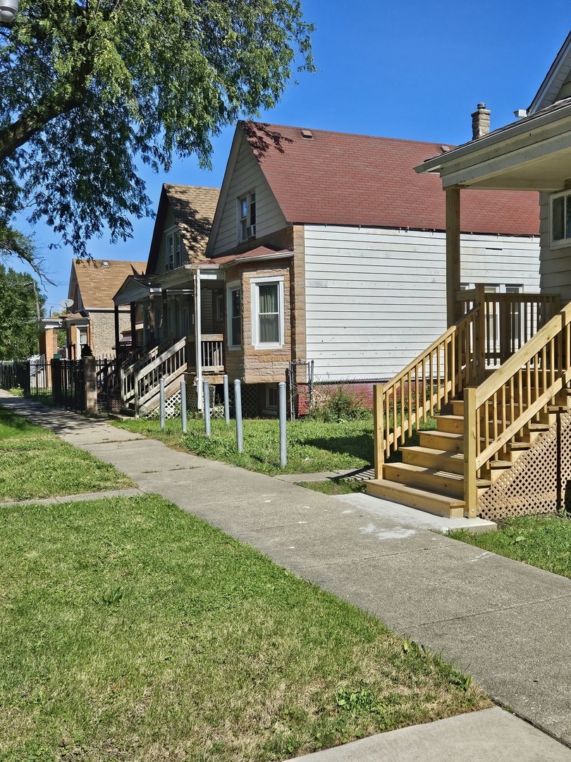 5943 South Marshfield Avenue Chicago, IL 60636 - Photo 5 of 5 a front view of a house with a yard