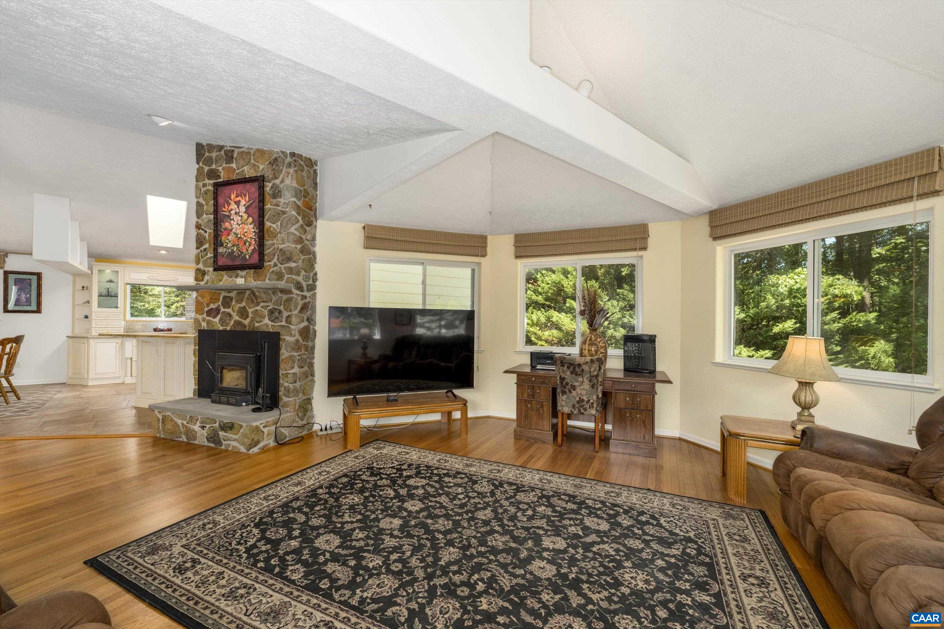 15365 Madison Run Road Gordonsville, VA 22942 - Photo 13 of 38 a living room with furniture a flat screen tv and a fireplace